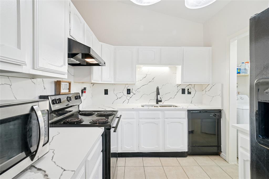 4522 Ebb Tide Drive Rowlett, TX 75088 - Photo 10 of 26 a kitchen with a sink a stove and refrigerator