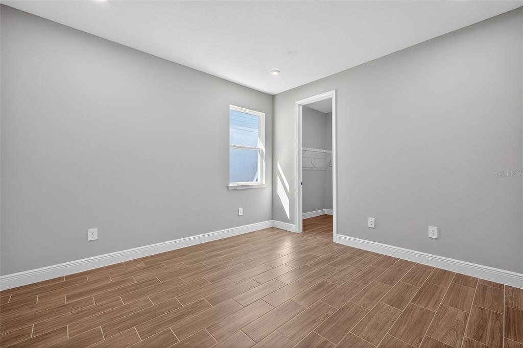 12349 49th Street East Parrish, FL 34219 - Photo 20 of 38 a view of an empty room with wooden floor and closet