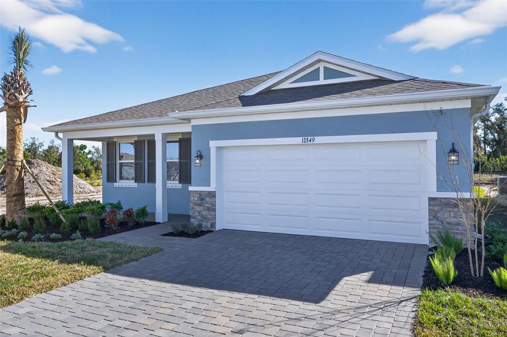 12349 49th Street East Parrish, FL 34219 - Photo 2 of 38 a front view of a house with garden