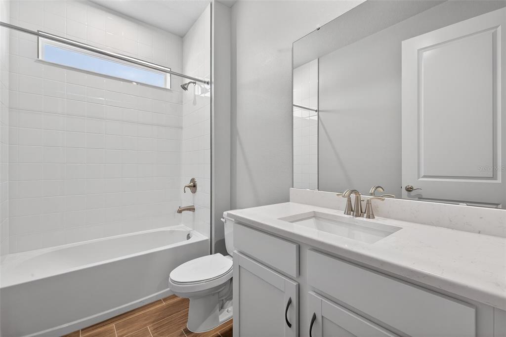 12349 49th Street East Parrish, FL 34219 - Photo 21 of 38 a bathroom with a sink a toilet and shower