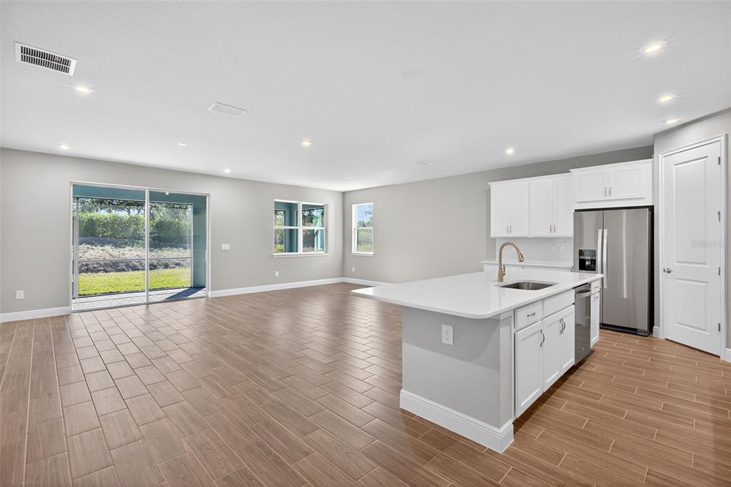 12349 49th Street East Parrish, FL 34219 - Photo 7 of 38 a view of a kitchen with a sink and a large window