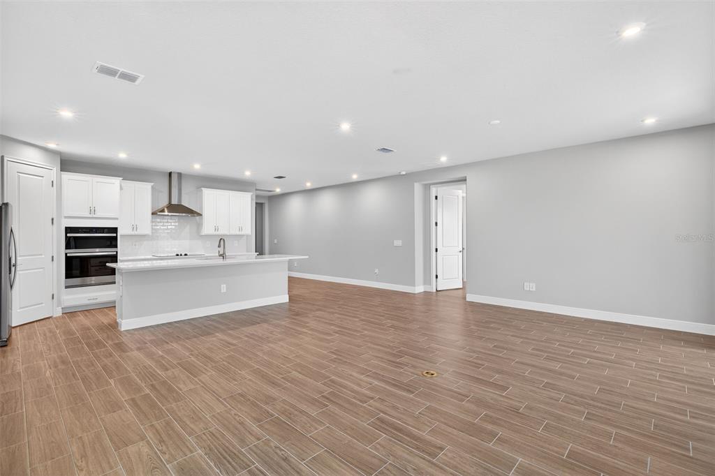 12349 49th Street East Parrish, FL 34219 - Photo 8 of 38 a large kitchen with stainless steel appliances granite countertop a large counter top and a oven