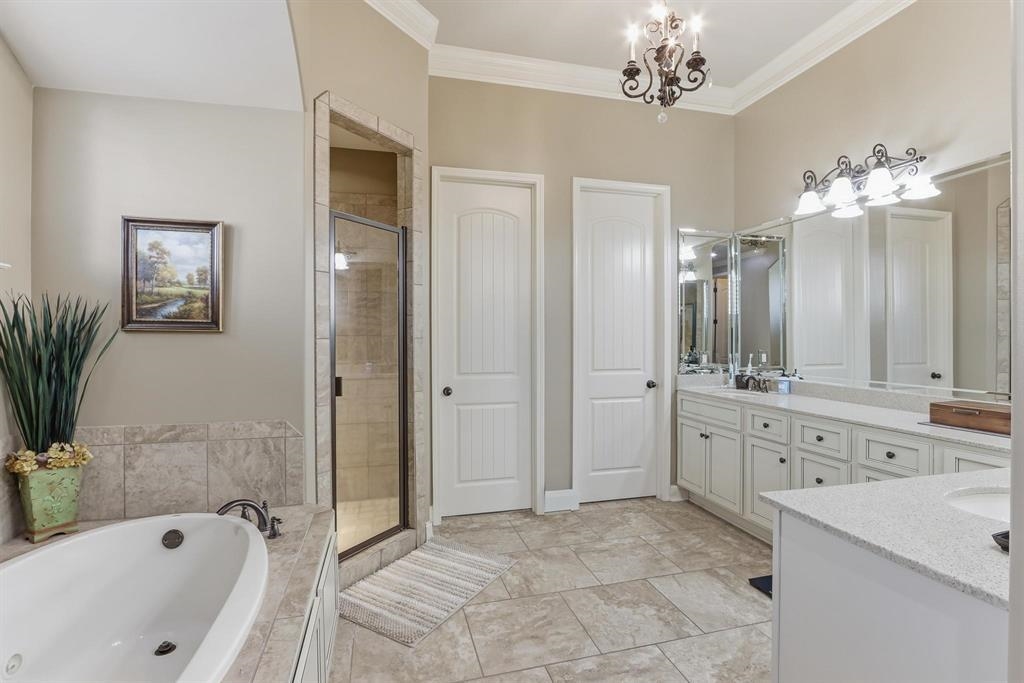1301 Conser Street Collierville, TN 38017 - Photo 17 of 39 a spacious bathroom with a tub sink a mirror a window and a shower