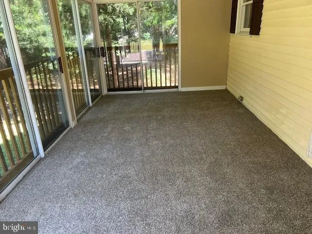 a view of a porch with wooden floor and fence