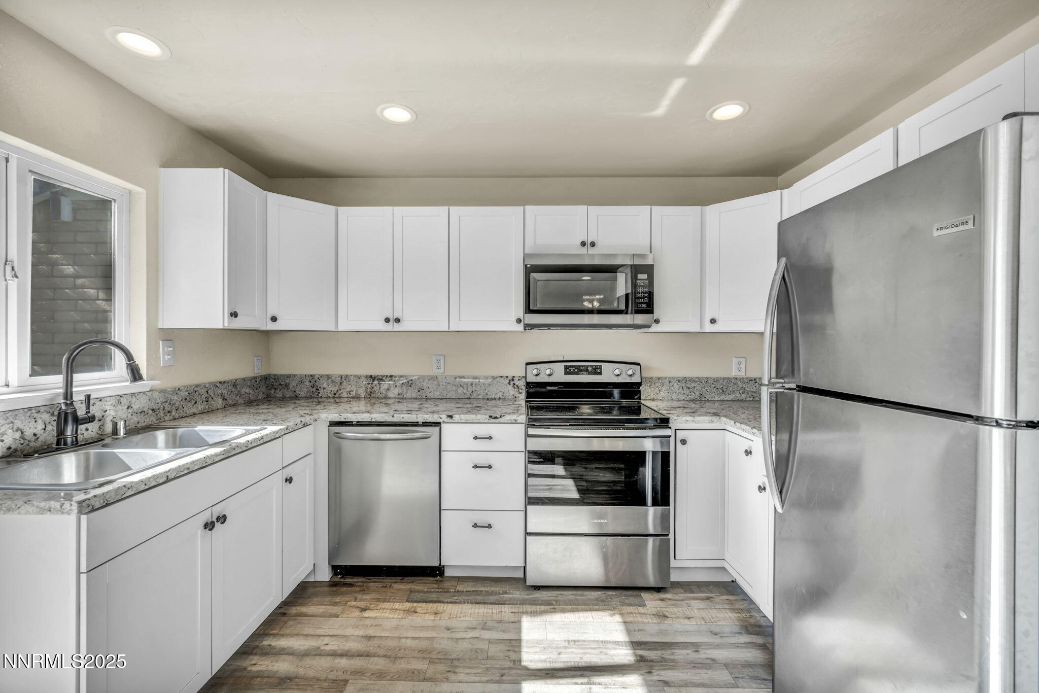 11 Castle Way Carson City, NV 89706 - Photo 11 of 34 a kitchen with a refrigerator sink and white cabinets