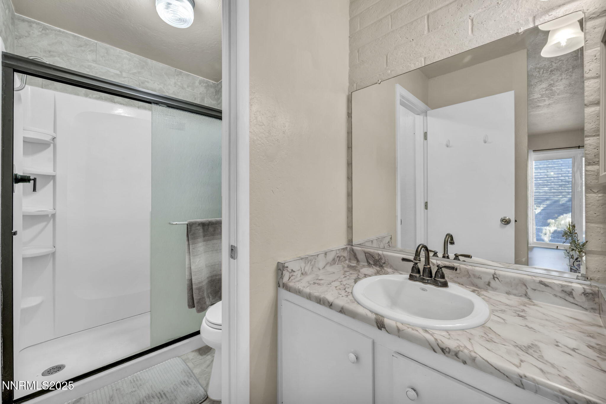 11 Castle Way Carson City, NV 89706 - Photo 20 of 34 a bathroom with a granite countertop sink and a mirror