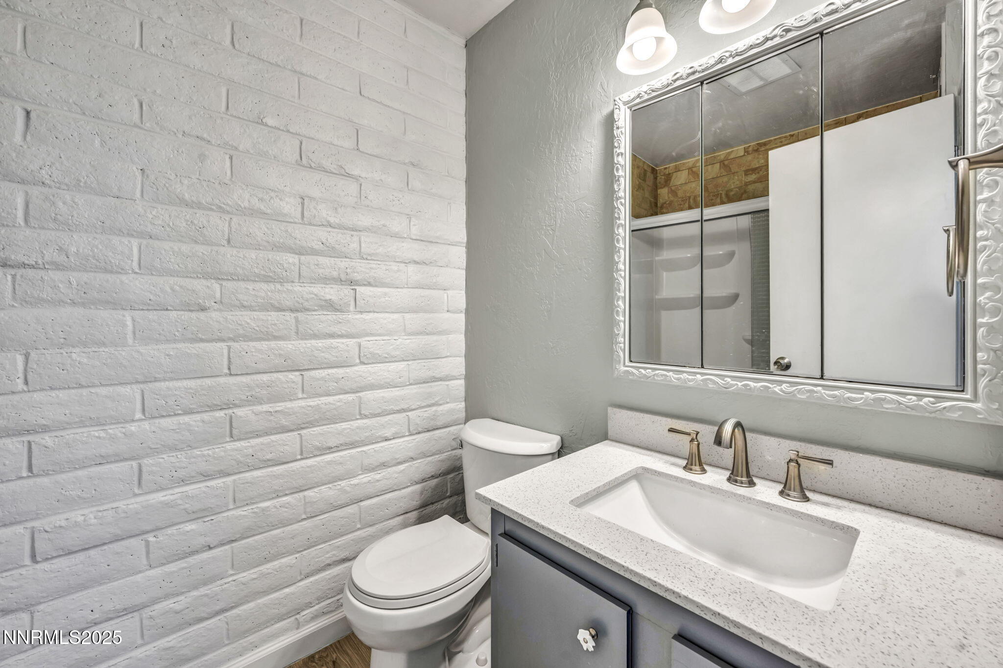 11 Castle Way Carson City, NV 89706 - Photo 26 of 34 a bathroom with a granite countertop toilet sink and mirror