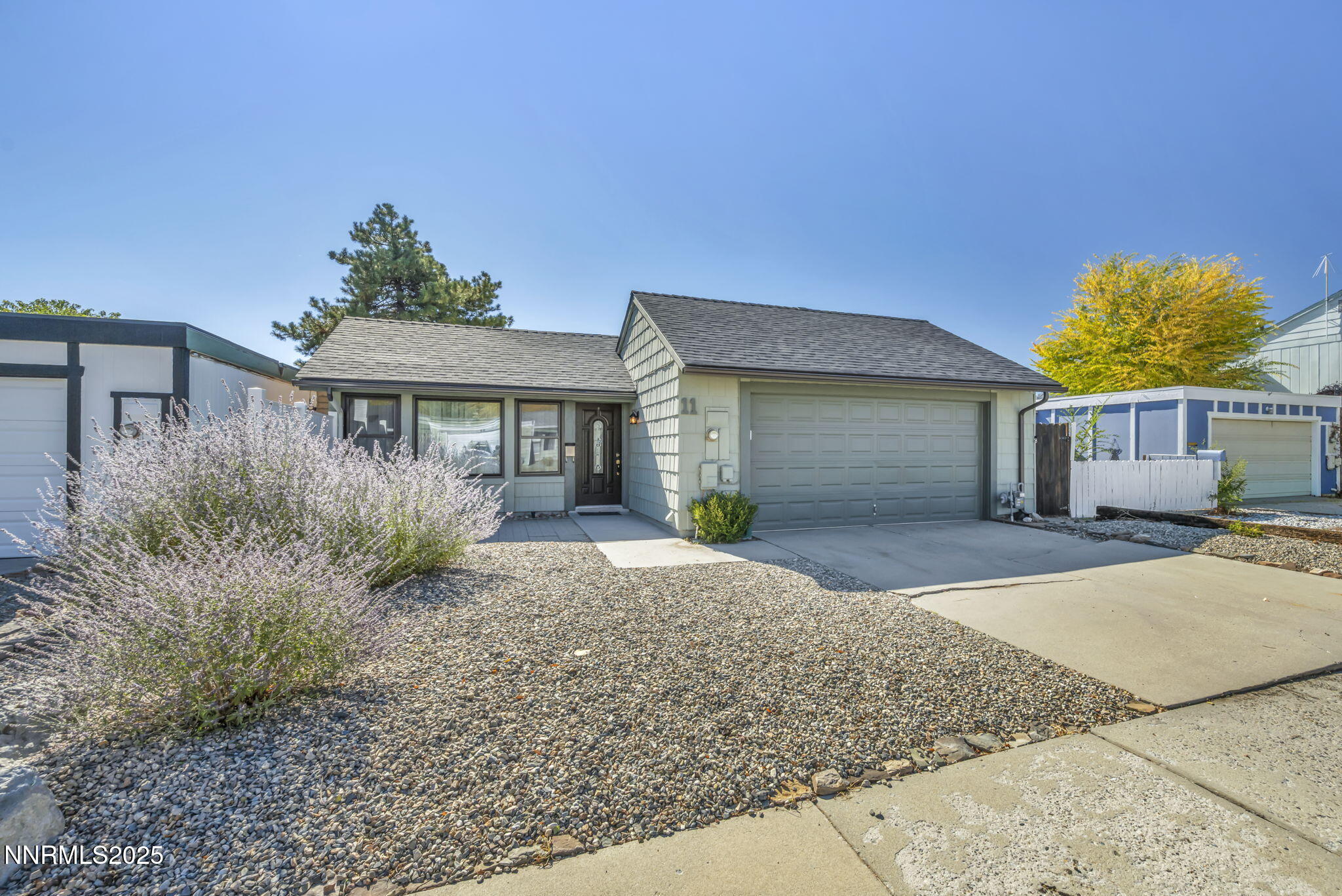 11 Castle Way Carson City, NV 89706 - Photo 3 of 34 a front view of a house with a yard and garage