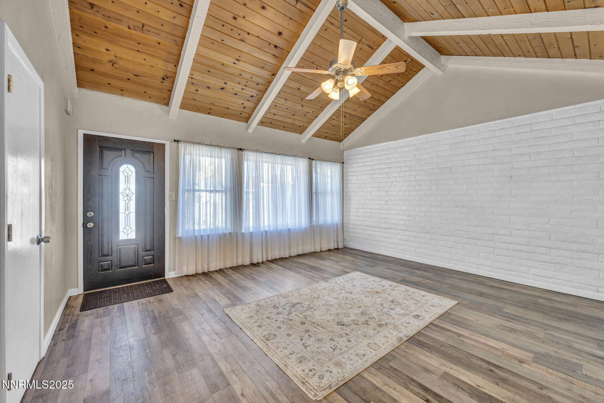 11 Castle Way Carson City, NV 89706 - Photo 5 of 34 a view of an empty room with wooden floor and a window