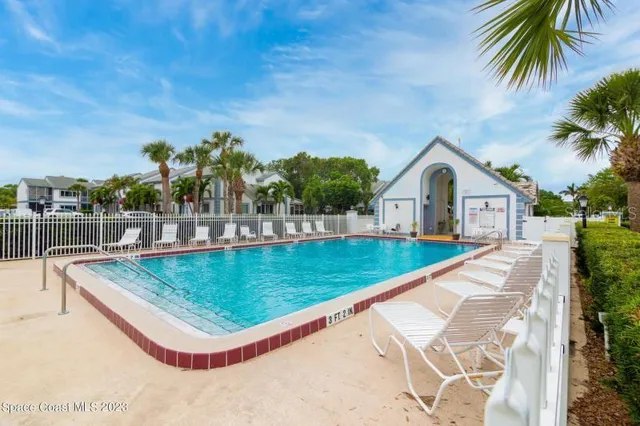 a view of a house with pool and a yard