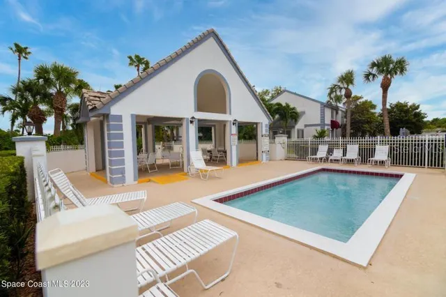 a view of a house with a yard and sitting area