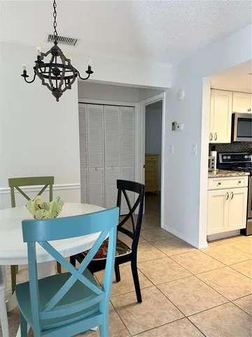 a view of a dining room with furniture and chandelier