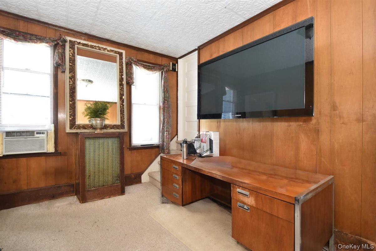 101 Wallace Street Freeport, NY 11520 - Photo 13 of 37 a room with a bed and a flat tv screen next to a window