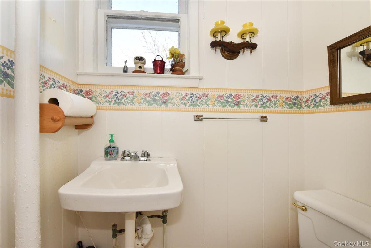 101 Wallace Street Freeport, NY 11520 - Photo 14 of 37 a bathroom with a sink and a mirror