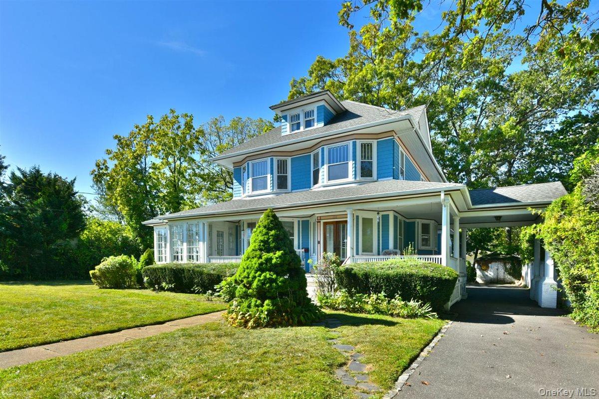 101 Wallace Street Freeport, NY 11520 - Photo 2 of 37 a front view of a house with a yard