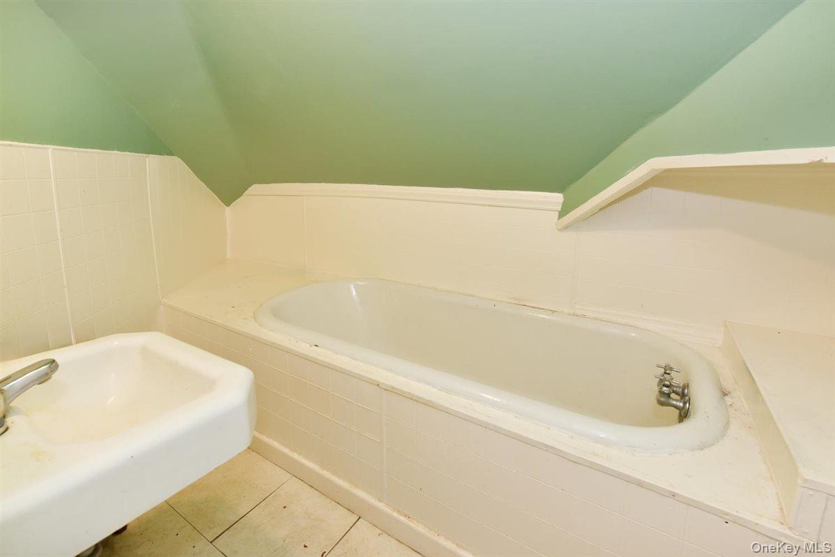 101 Wallace Street Freeport, NY 11520 - Photo 25 of 37 a bathroom with a bathtub