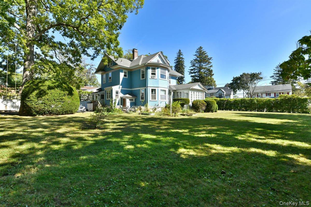 101 Wallace Street Freeport, NY 11520 - Photo 30 of 37 a front view of a house with a yard