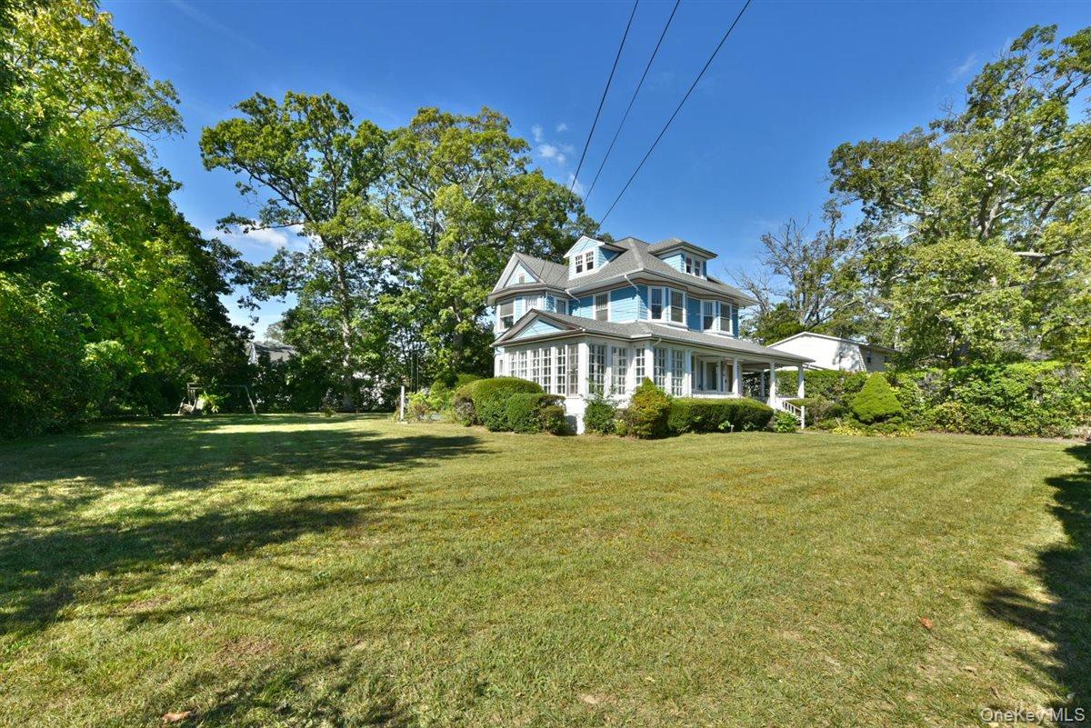 101 Wallace Street Freeport, NY 11520 - Photo 34 of 37 a front view of a house with a garden