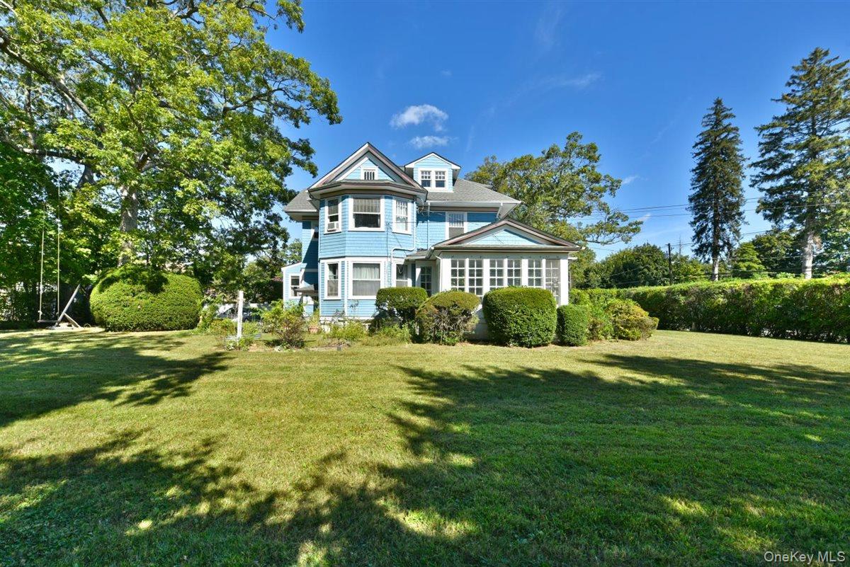 101 Wallace Street Freeport, NY 11520 - Photo 36 of 37 a front view of a house with a yard