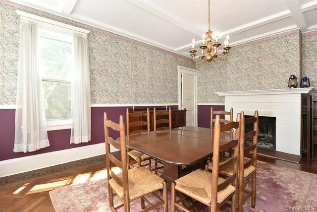 a dining room with furniture a chandelier and wooden floor