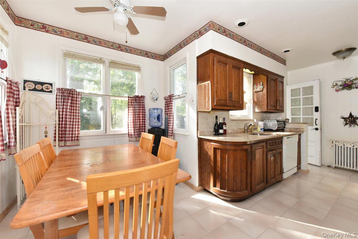 101 Wallace Street Freeport, NY 11520 - Photo 10 of 37 a large kitchen with kitchen island granite countertop a large window and stainless steel appliances