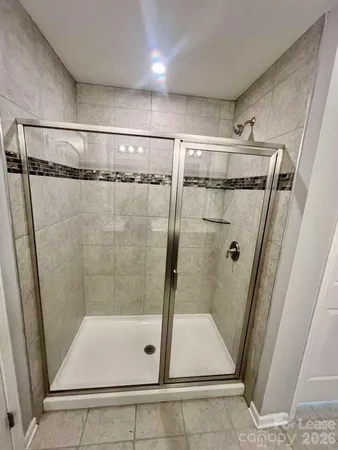 a bathroom with a glass shower door