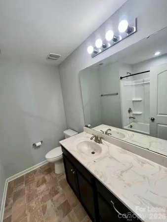 a bathroom with a sink vanity and a mirror