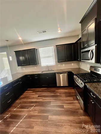 a kitchen with stainless steel appliances and cabinets