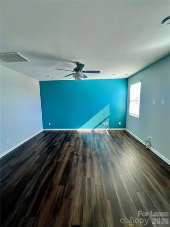 a view of a room with wooden floor