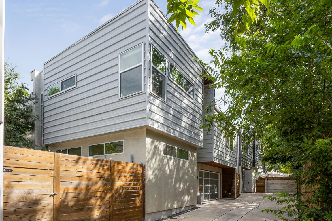 View of home's exterior with a patio area, driveway, and a garage