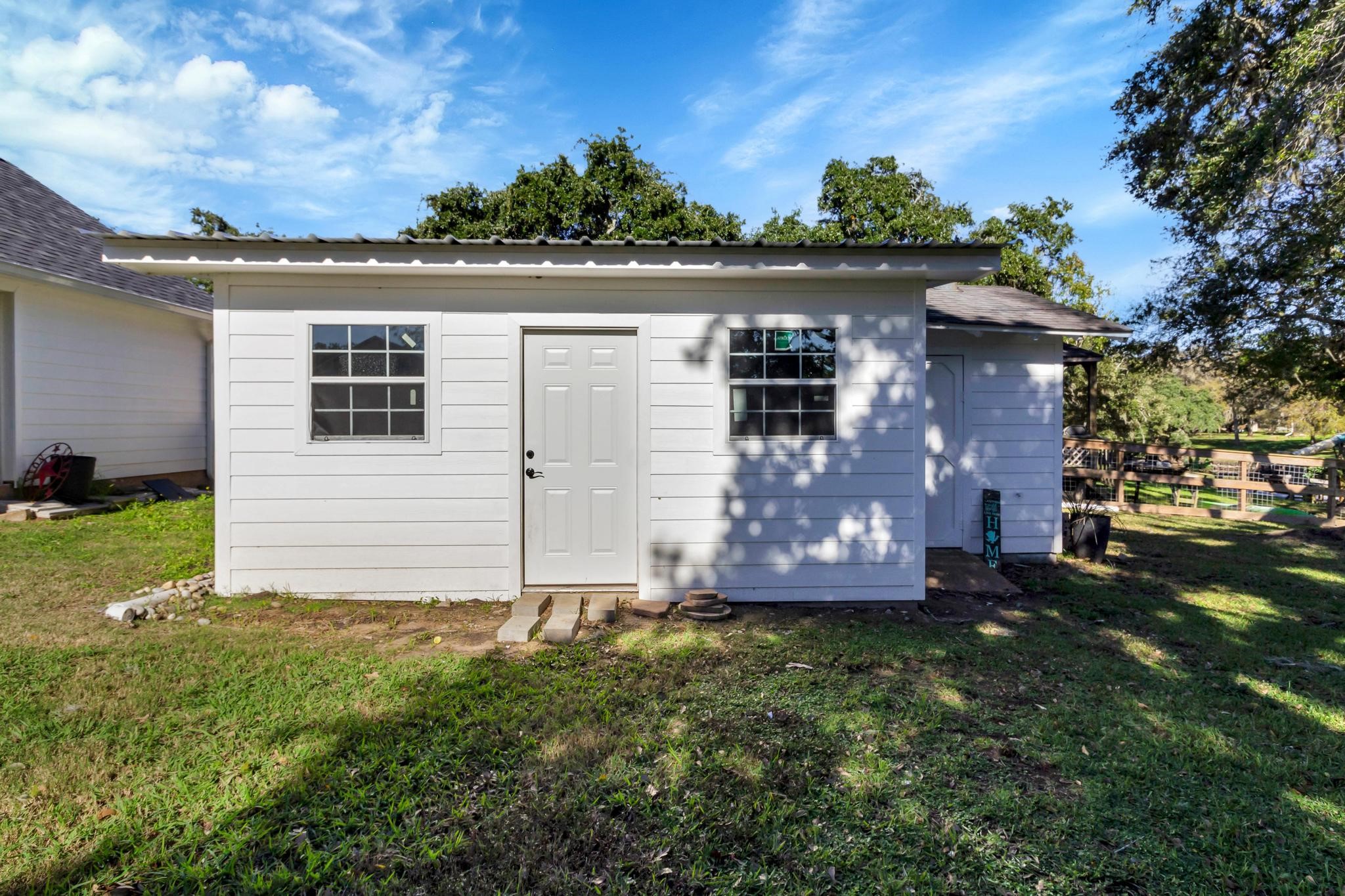 295 County Road 687 Angleton, TX 77515 - Photo 13 of 38 This photo shows the exterior of the finished outbuilding, including a window air conditioner.
