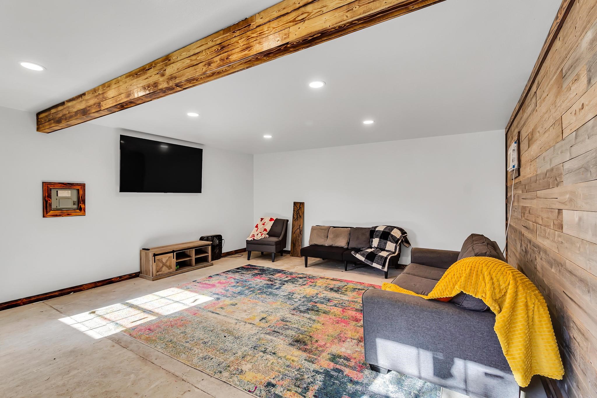 295 County Road 687 Angleton, TX 77515 - Photo 14 of 38 The interior of the outbuilding features a wood accent wall, exposed beam ceiling, and ample lighting. This space could be your office, work out room, art studio or many other possibilities.