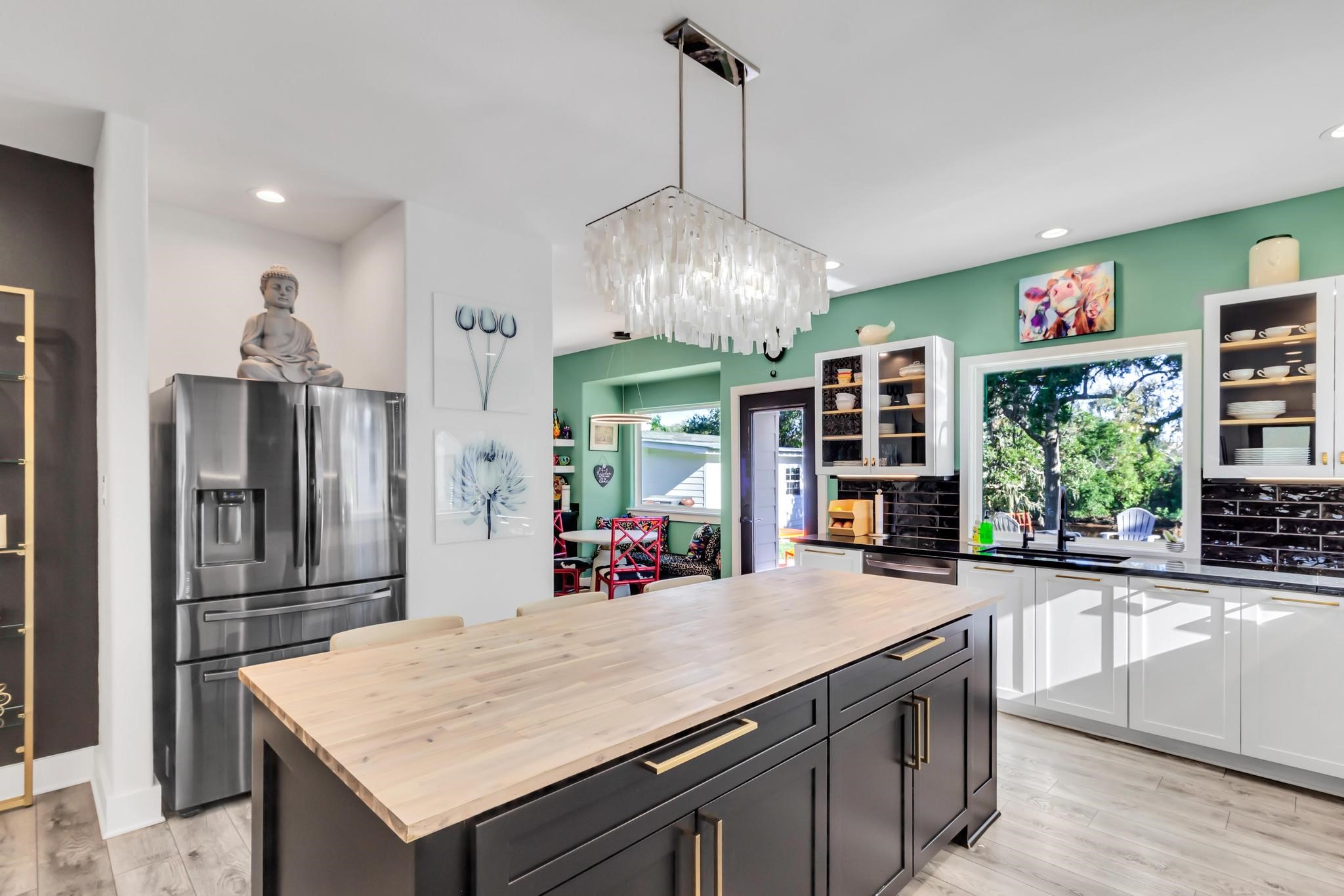 295 County Road 687 Angleton, TX 77515 - Photo 20 of 38 This kitchen features modern design with stylish lighting, ample storage and a vibrant accent wall for a touch of color.
