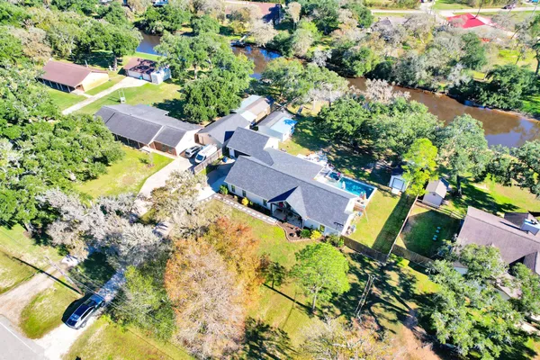 an aerial view of a house with a yard and garden