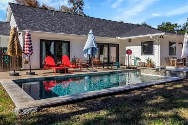 a view of swimming pool with an outdoor seating