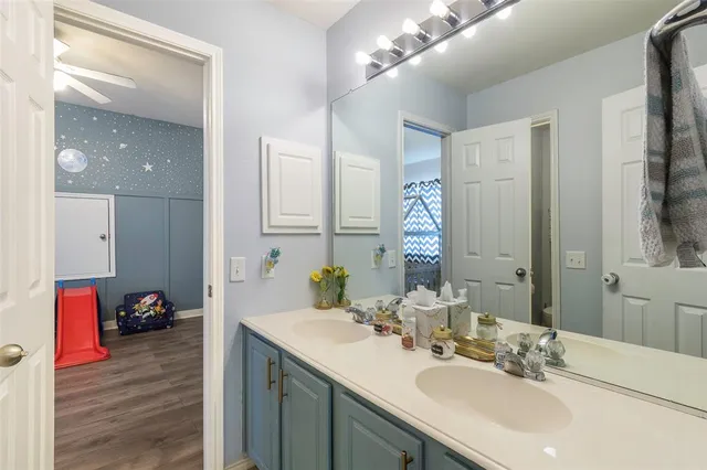 a bathroom with a sink vanity and a mirror