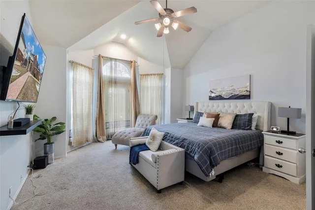 a bedroom with a large bed and a chandelier