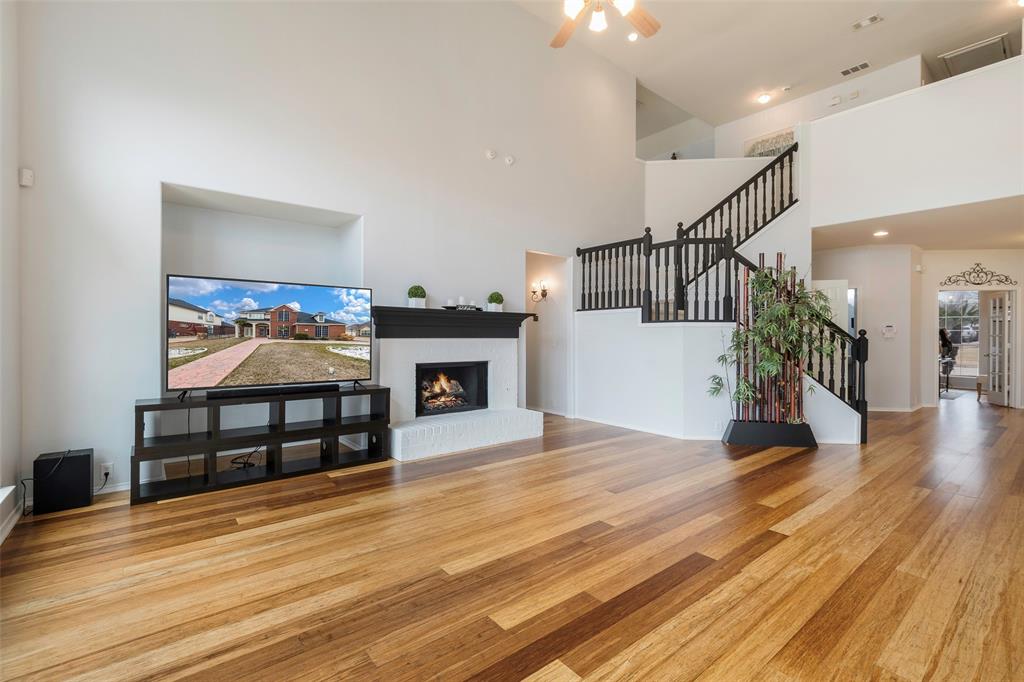 3010 St Joseph Drive Mansfield, TX 76063 - Photo 3 of 33 a view of a livingroom with wooden floor and a fireplace