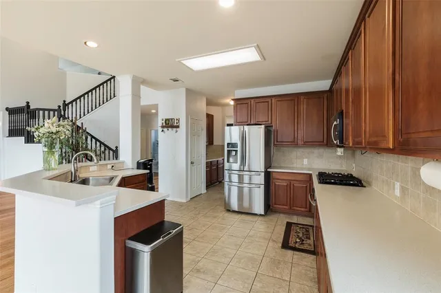 a kitchen with refrigerator and cabinets