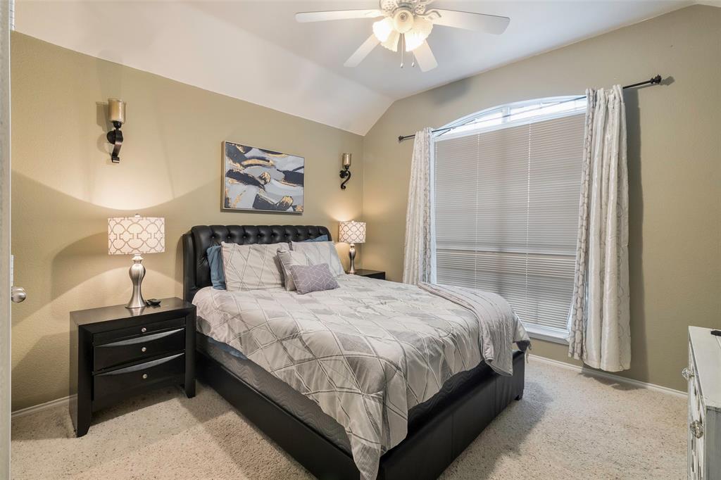 3010 St Joseph Drive Mansfield, TX 76063 - Photo 9 of 33 a bedroom with a bed and a chandelier