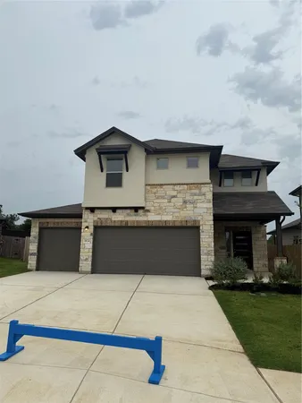 a front view of a house with garage