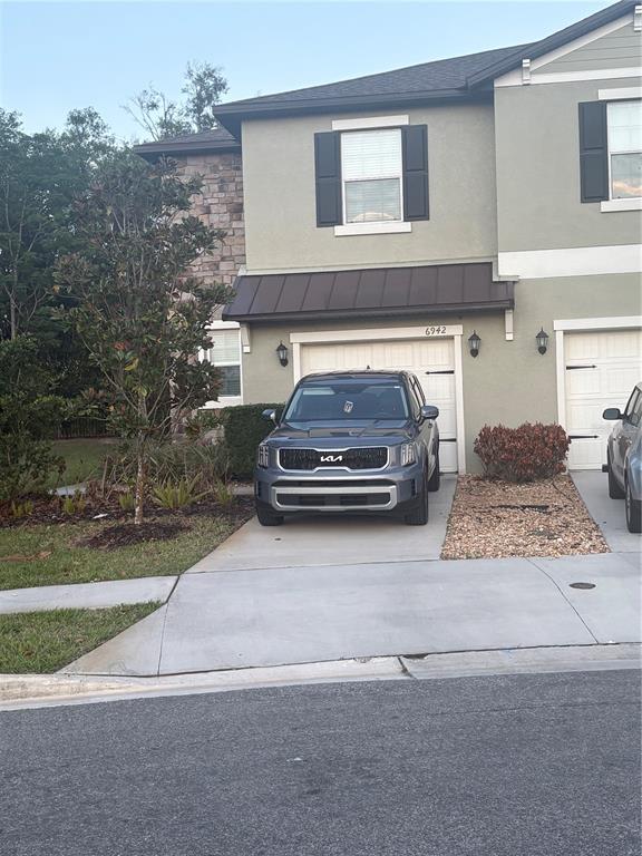 6942 Ripple Pond Loop Zephyrhills, FL 33541 - Photo 1 of 1 a car parked in front of a building