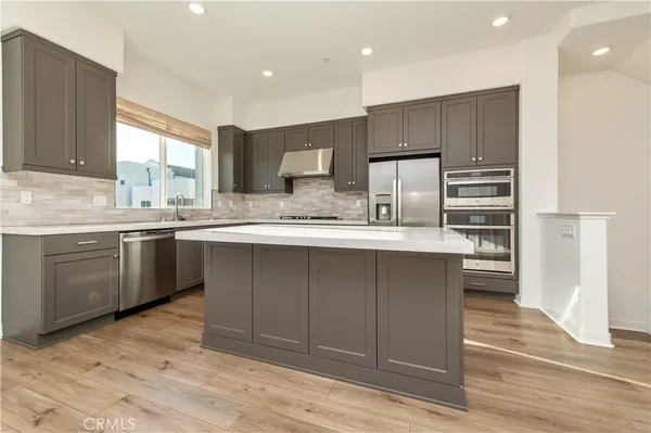 a kitchen with a sink stainless steel appliances and cabinets