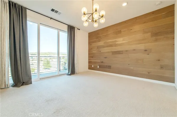 en empty room with closet and chandelier fan