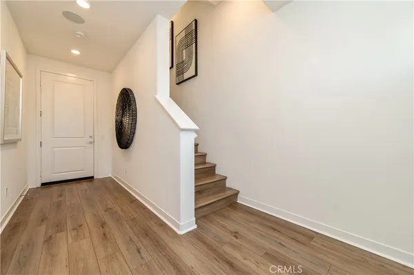 a view of a room with wooden floor and white walls