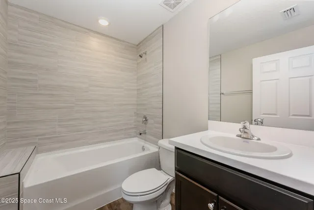 a bathroom with a sink a toilet and bathtub