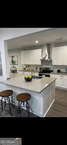 a kitchen with stainless steel appliances granite countertop a stove a sink and a refrigerator