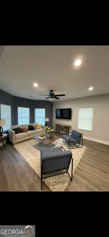 a living room with furniture and a flat screen tv