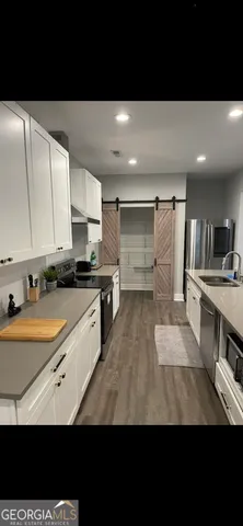 a kitchen with stainless steel appliances kitchen island granite countertop a sink and cabinets