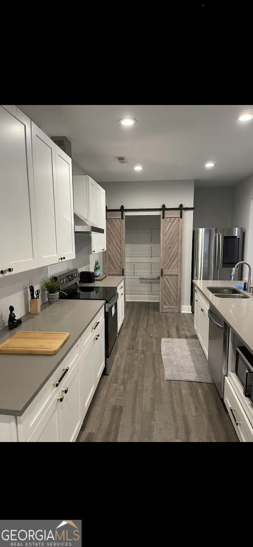 966 McDaniel Street Southwest Atlanta, GA 30310 - Photo 5 of 10 a kitchen with stainless steel appliances kitchen island granite countertop a sink and cabinets